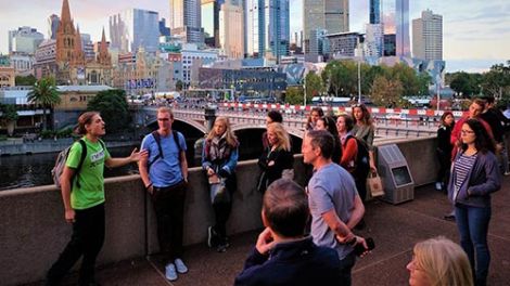 A group of people on a walking sightseeing tour of Melbourne