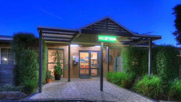 Exterior view of Airport Tourist Village Melbourne reception at night