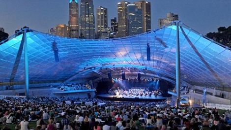 A large crowd watching an outdoor concert at night in Melbourne