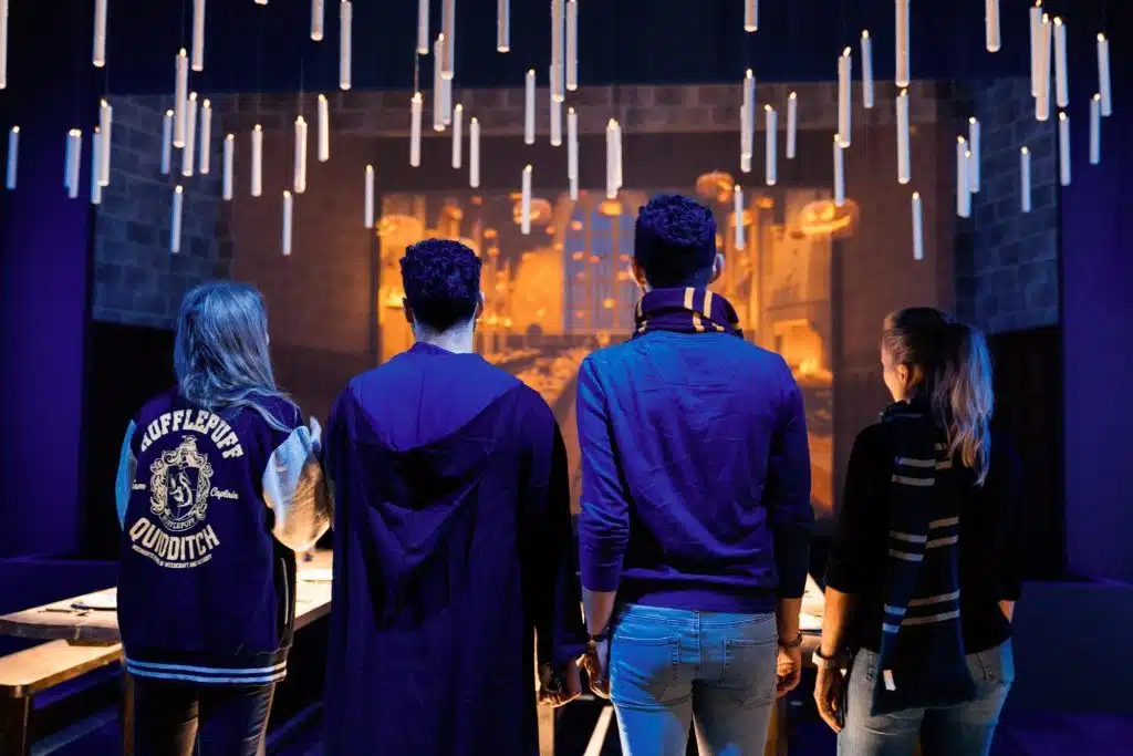 People wearing Harry Potter outfits at a Harry Potter exhibition