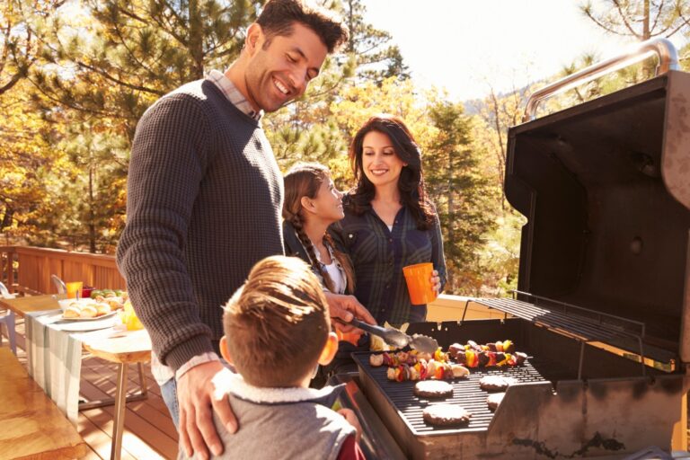 Family barbeque outside having fun. What makes ATVM a great option for families during the school holidays?