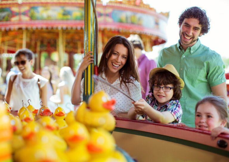 Melbourne school holidays 2025. Family at a theme park playing carnival games and having fun. Duck catch game
